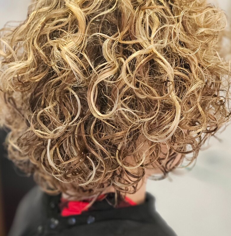 Blonde curly shape and colour detail by Riverside Hair
